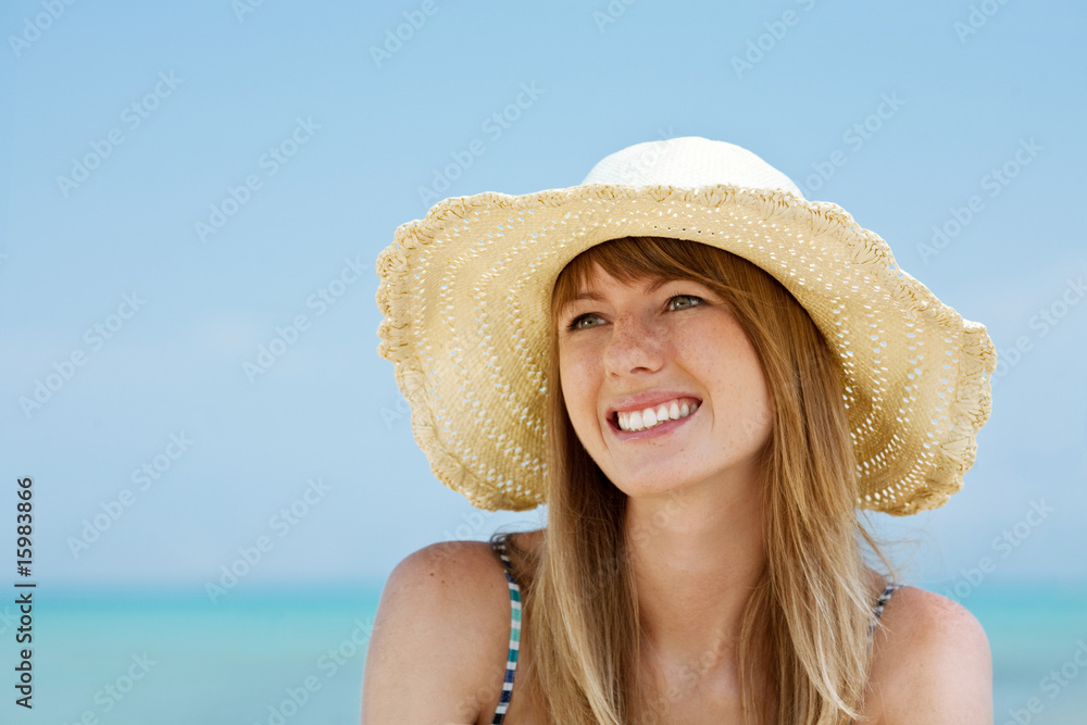 Beautiful young woman smiling on the beach