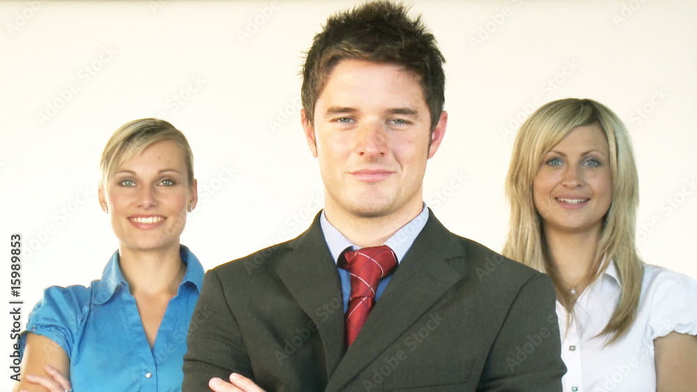 Confident businessman with businesswomen in the background Confident businessman with businesswomen in the background