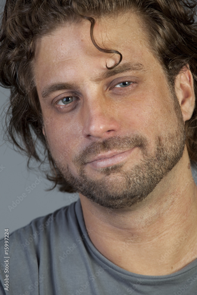 Closeup portrait of a smiling young man isolated