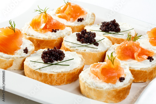 Mini sandwiches - bagel with cream cheese, salmon, caviar