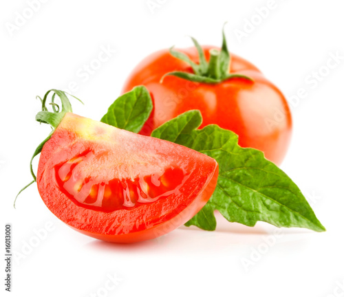 red tomato vegetable with cut and green leaves