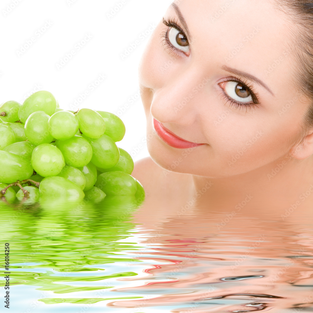 pretty woman with green grape isolated on the white background pretty woman with green grape isolated on the white background