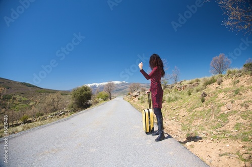 woman hitch-hiking on the road © Q