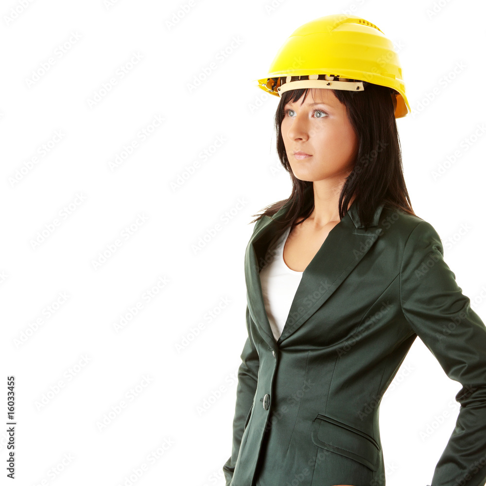 Young female architect or builder wearing a yellow hart hat Young female architect or builder wearing a yellow hart hat