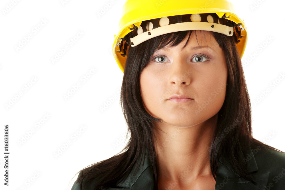 Young female architect or builder wearing a yellow hart hat Young female architect or builder wearing a yellow hart hat