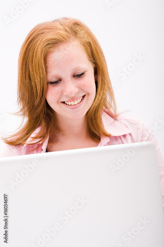 Beautiful freckled teen with computer