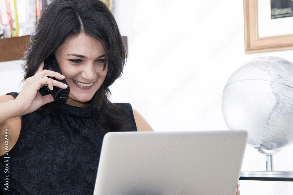 Woman working with phone and laptop Woman working with phone and laptop