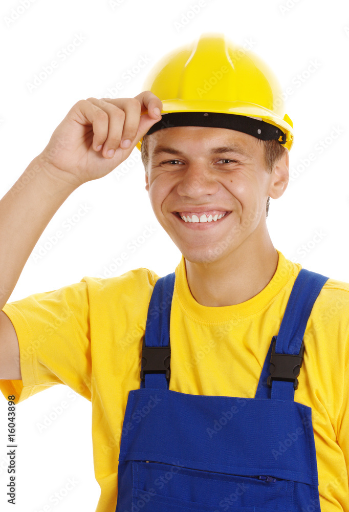 Young worker taking off his hard hat and smile Young worker taking off his hard hat and smile