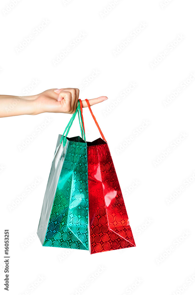 Hand holding gift bags isolated on white