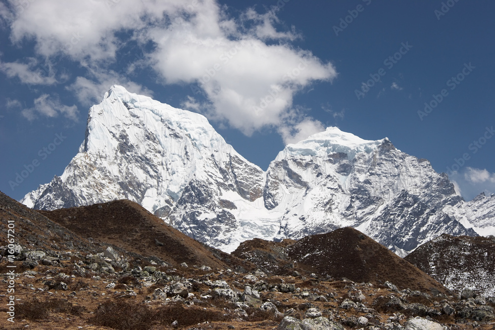 Cholatse and Taboche snow mountains above grass hills, Himalaya, Nepal