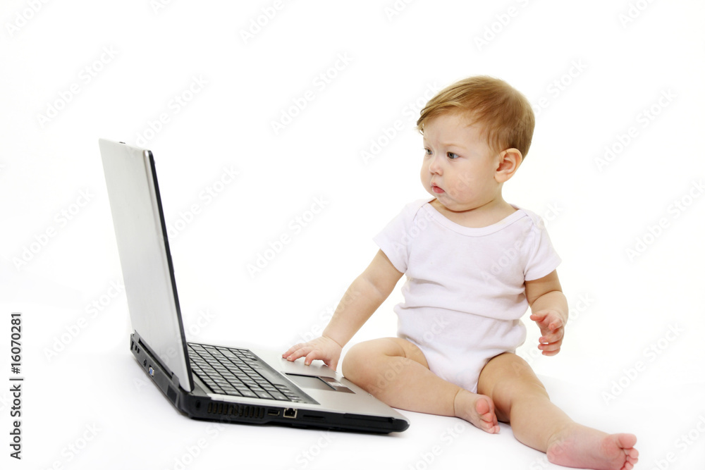 Small baby with laptop isolated on white Small baby with laptop isolated on white