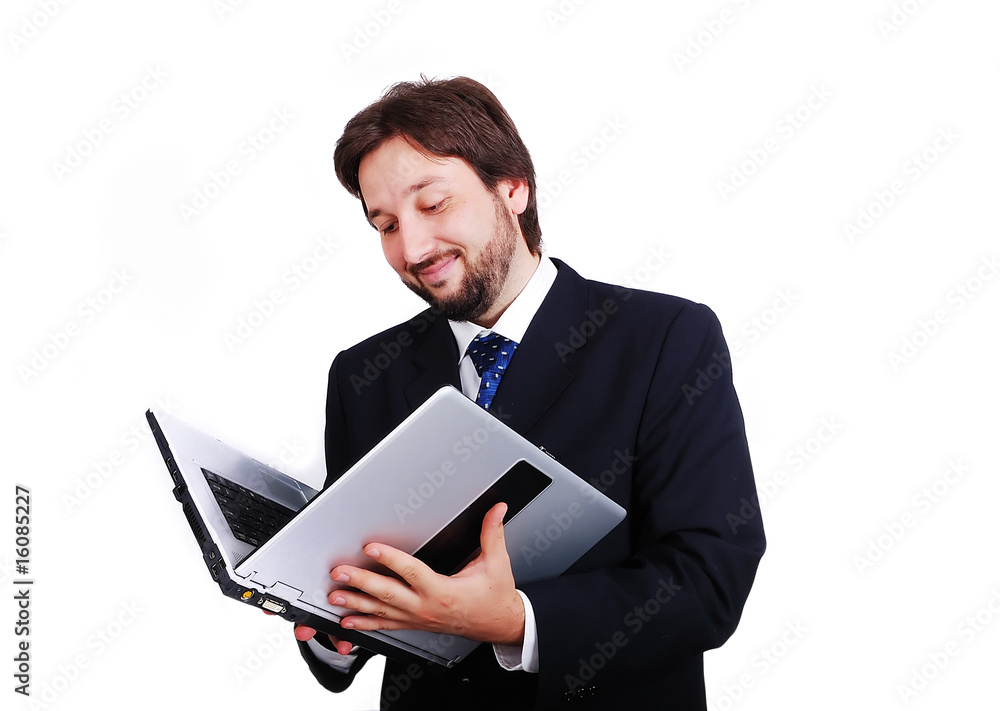 Young male standing with laptop as a book Young male standing with laptop as a book