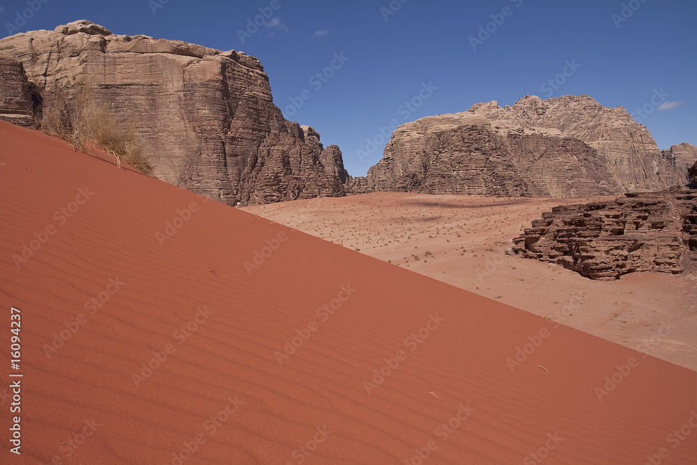 Desert landscape with mountains and dunes.