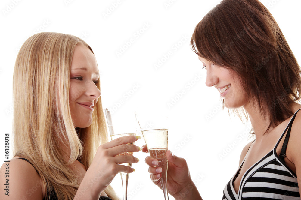 Two casual young women enjoying champagne Two casual young women enjoying champagne