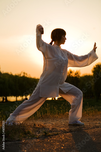 woman in white suit make's taiji chuan exercise - 7