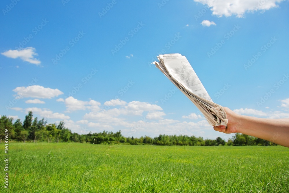 Fototapeta premium hand holding newspaper at outdoor