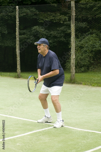 active healthy retired senior man playing tennis © robert lerich