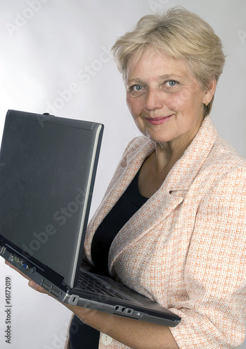 Photography happy older pensioner woman with computer