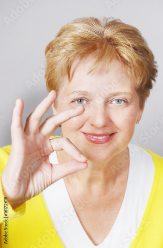 Photography mid aged woman with OK gesture