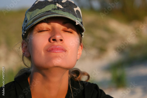 Portrait of beautiful woman with camouflage cap