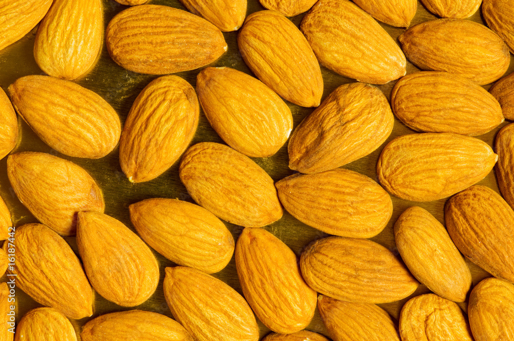 Fototapeta premium Fresh almonds arranged as a background