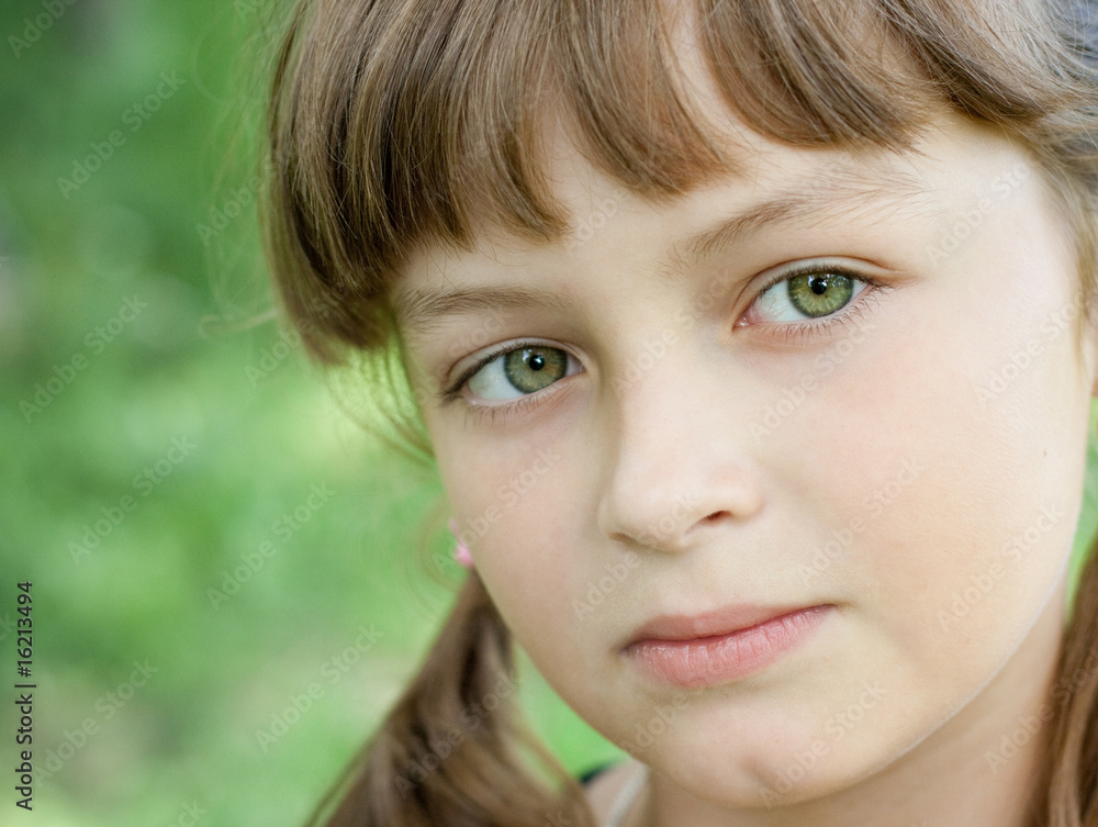 Fullface portrait of serious little girl with green eyes Fullface portrait of serious little girl with green eyes