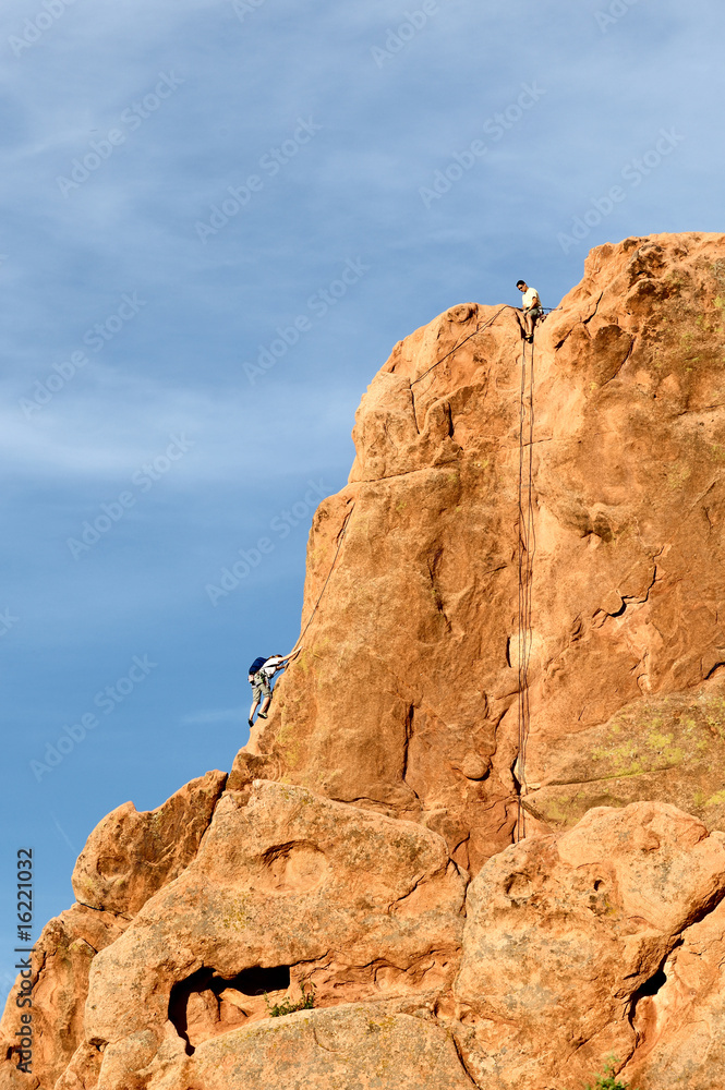 Fototapeta premium Rock climber climbing a cliff