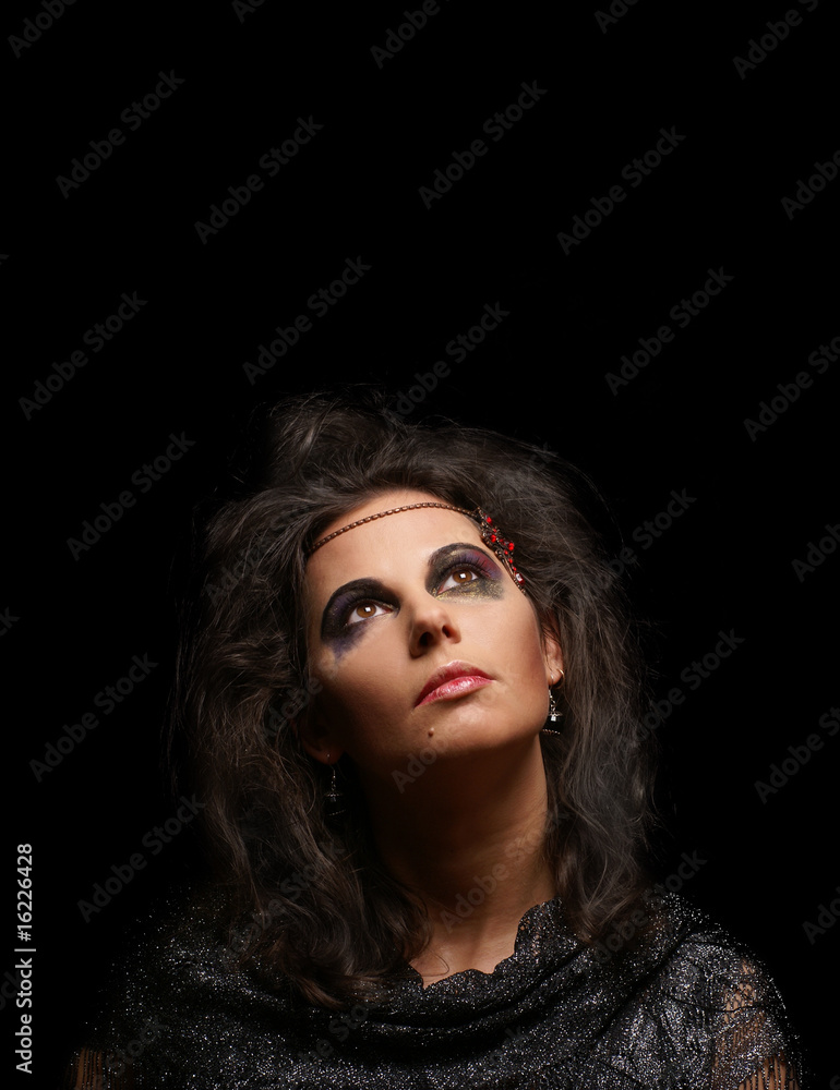 Fototapeta premium Portrait of witch over dark background