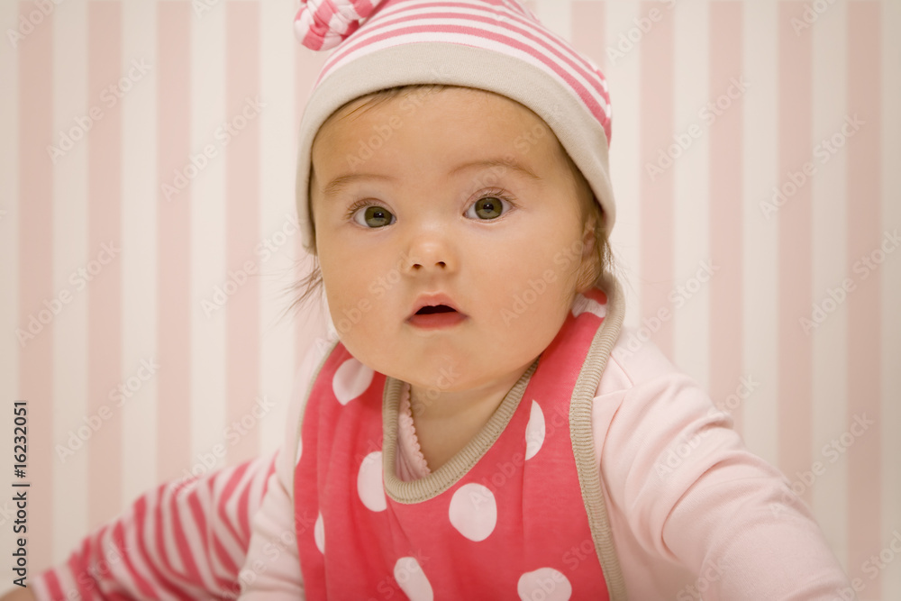 Portrait of newborn baby in striped red wear