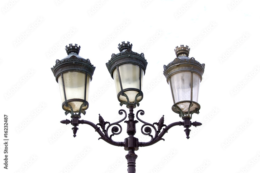 Three old-fashioned lamps on white
