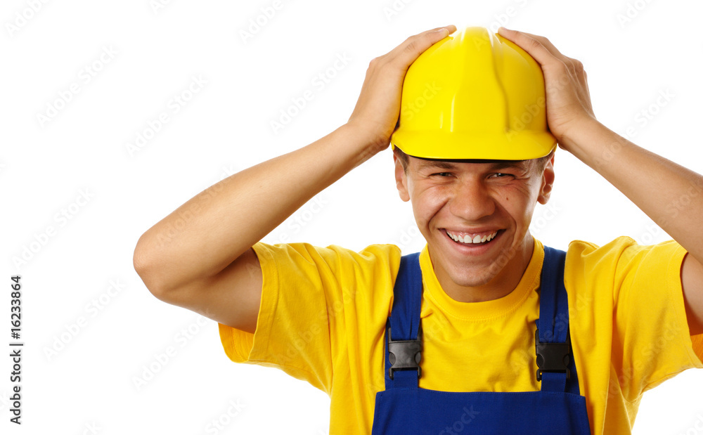 Happy young worker put his hands on hard hat Happy young worker put his hands on hard hat