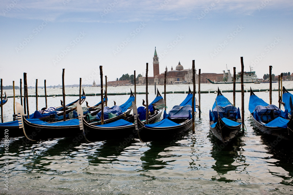 Blue and black gondolas on canal