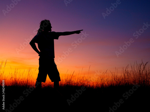 Young man silhouette in sunsetA