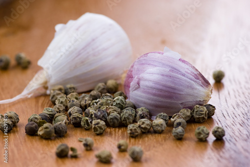 Close up of garlic and green peppercorns photo