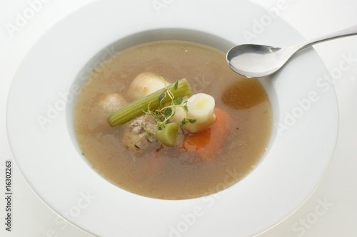 healthy soup with organic vegetables and a spoon