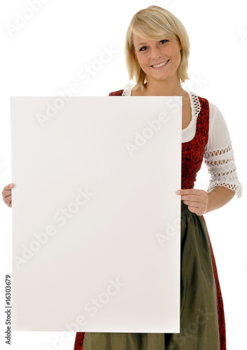 Junge Frau im Dirndl hält Schild photo