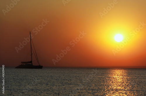 ship silhouette on sunset sea background