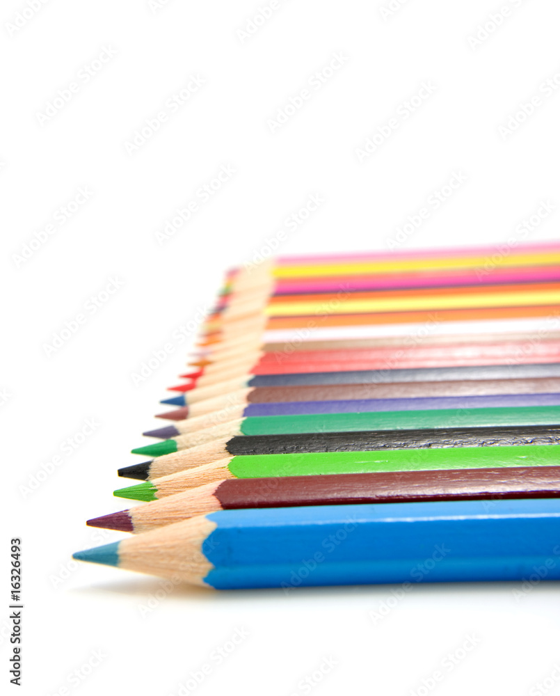 colored pencils in a row over white background colored pencils in a row over white background