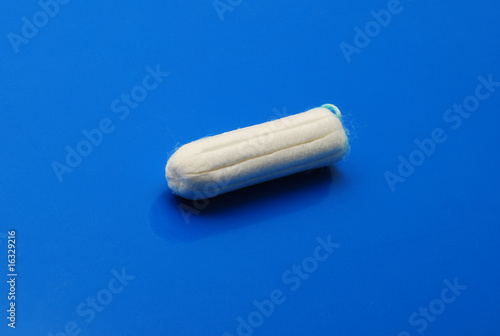 tampon over blue background photo