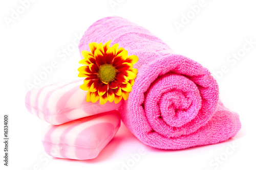 soap, flower and towel on white.