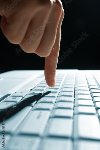 male hands typing on a laptop