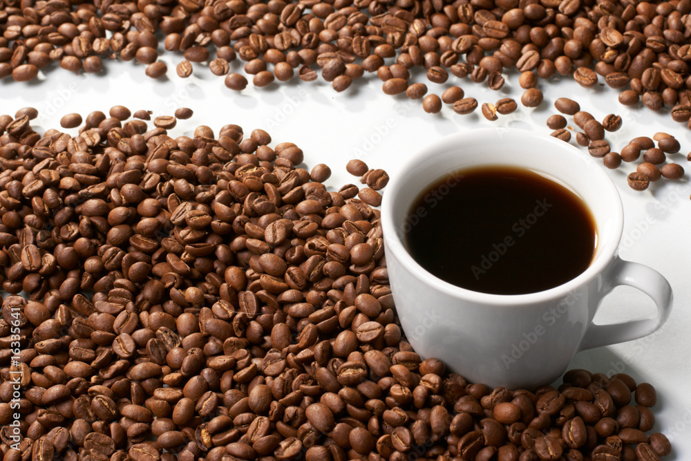 Fototapeta premium Cup with coffee, costing on coffee grain
