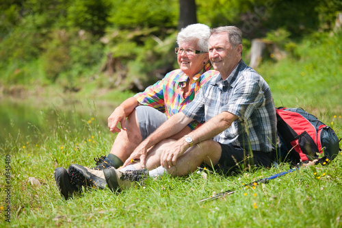 elderly couple sitting in grass © amriphoto.com