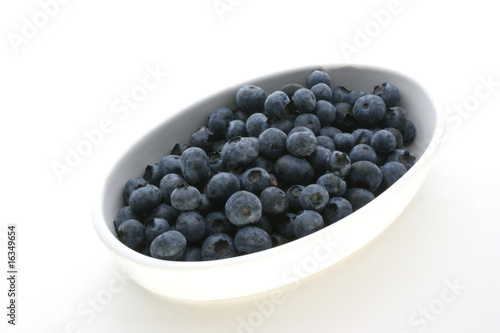 some sweet organic elderberries in a white bowl