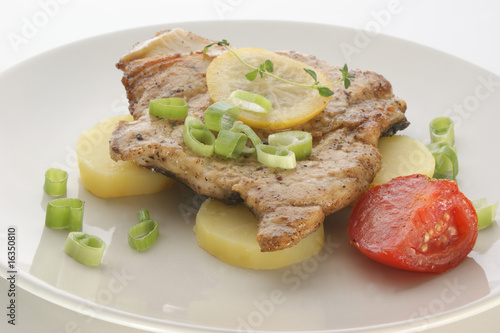 carp steak with potato and tomato