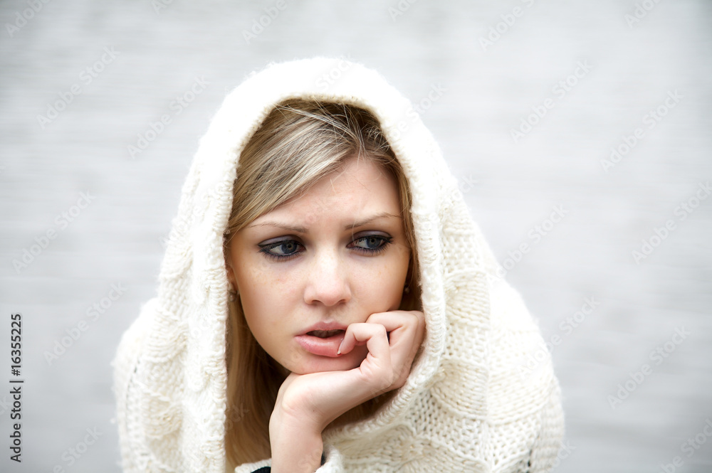 Obraz premium The thoughtful girl in knitted dress