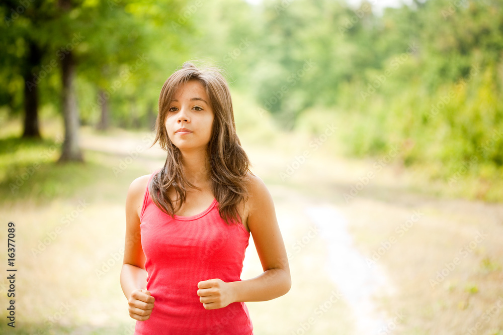 Woman jogging through a forest