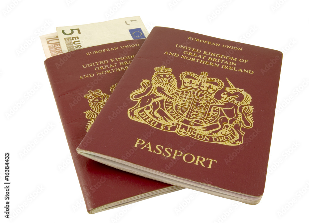 two british passports with euros isolated on white two british passports with euros isolated on white