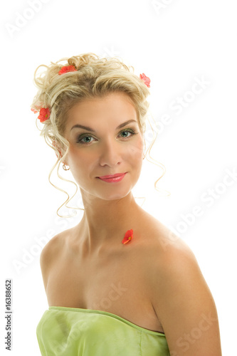 Beautiful young woman with fresh spring flowers in her hair clos