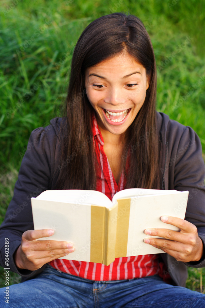 Excited woman reading a book Excited woman reading a book